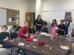 Church youth working on a craft project around a large table
