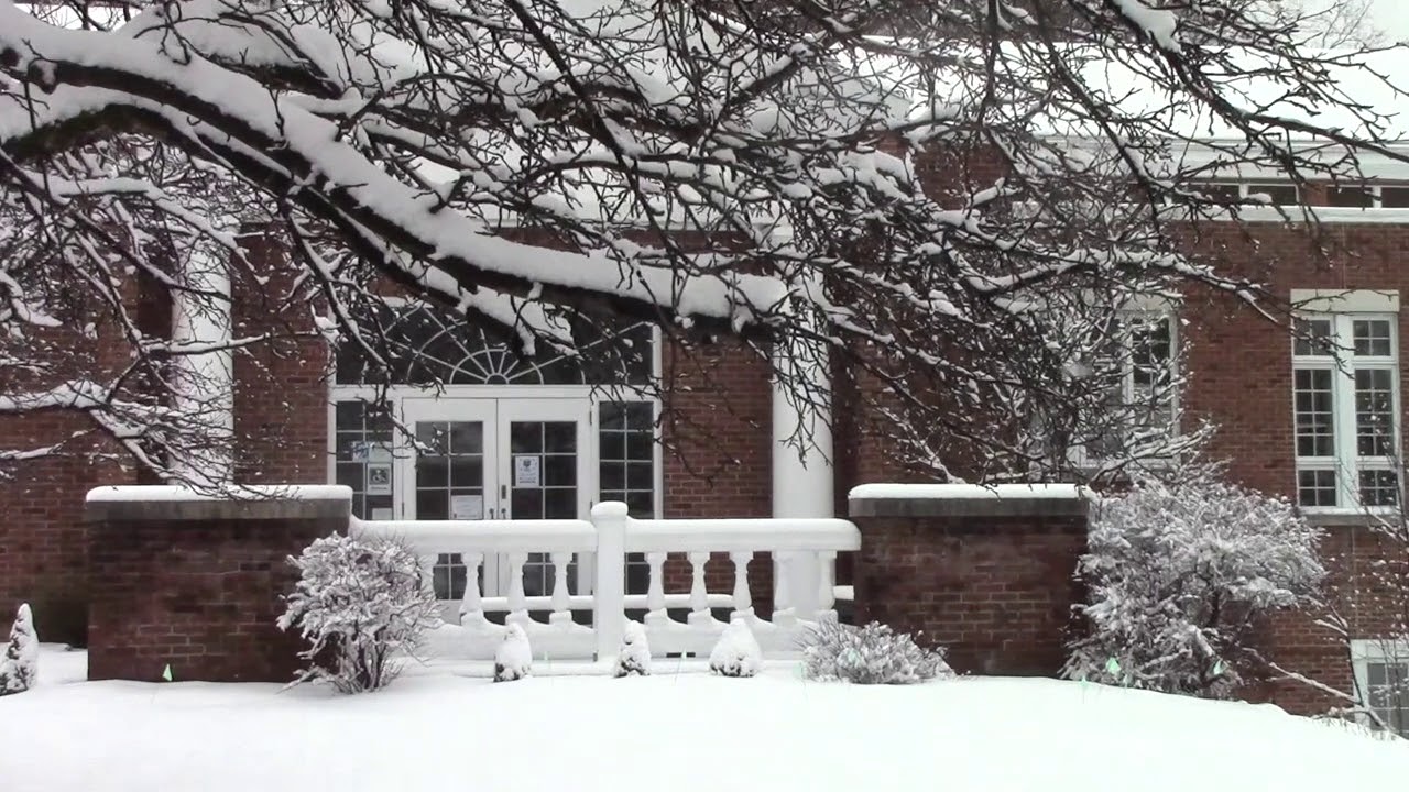 The snow-covered entrance of the brick First Congregational Church building