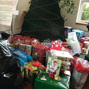 Wrapped boxes of gifts donated for the Giving Tree, to be distributed to local organizations serving youth and families