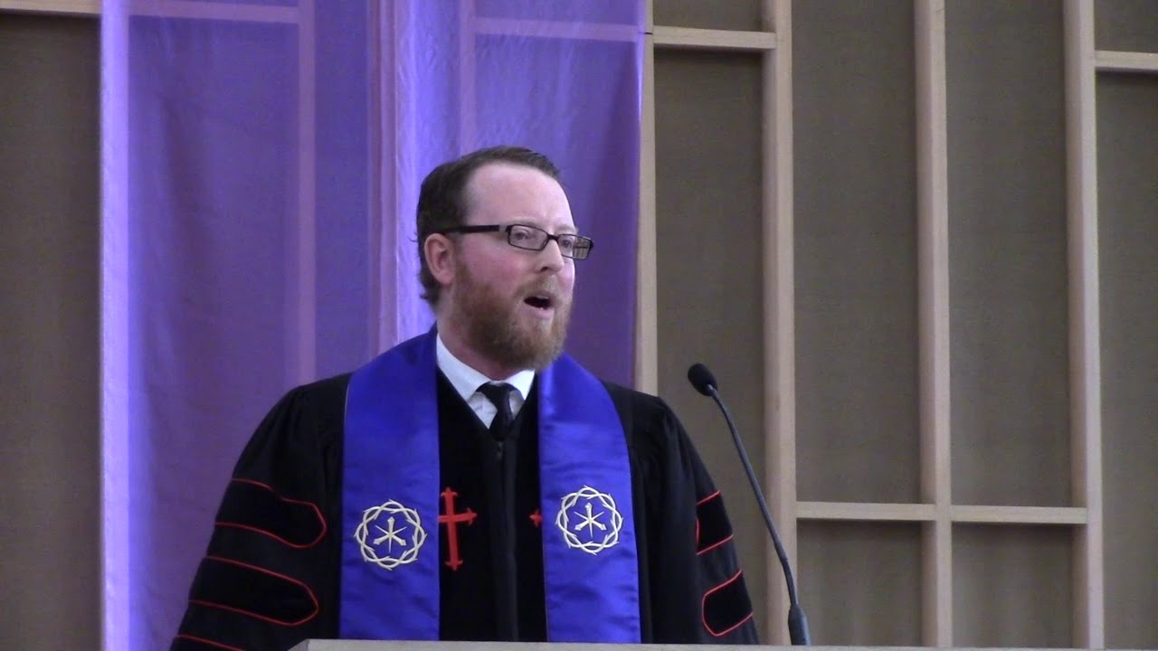 Senior Minister David Kaden standing at the pulpit