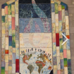 multicolored quilt with an image of the earth representing communication between people and God