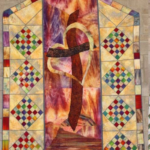 multicolored quilt with geometric shapes representing the Cross